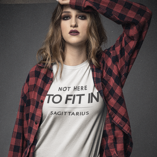 Model wearing Sagittarius zodiac t-shirt with “Not Here to Fit In” typography quote design