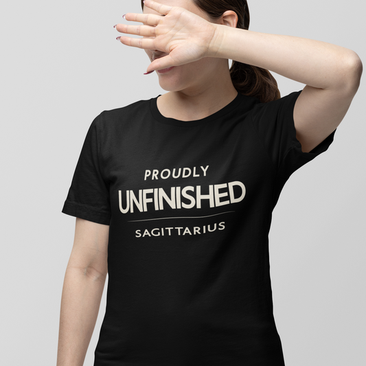 Model wearing Sagittarius zodiac t-shirt with “Proudly Unfinished” typography quote design