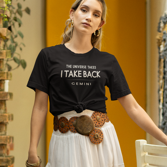 Model wearing Gemini zodiac t-shirt with “The Universe Takes I Take Back” bold typography design