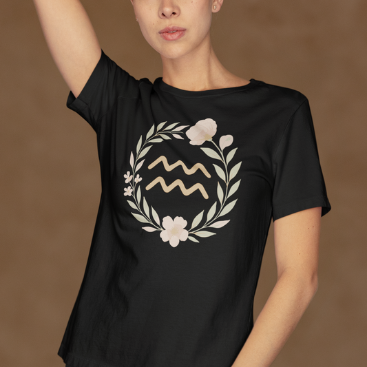 Model wearing Aquarius t-shirt with floral zodiac symbol astrology design.