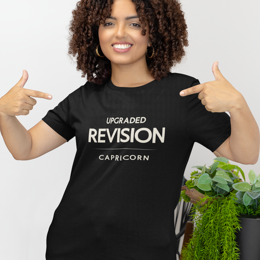 Model wearing Capricorn zodiac t-shirt with “Upgraded Revision” typography quote design