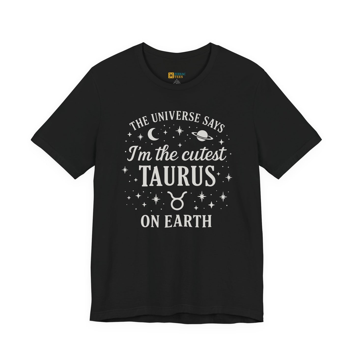 A black T-shirt featuring a white Taurus zodiac design that reads “The Universe Says I’m the Cutest Taurus on Earth,” decorated with celestial stars, a moon, a planet and the Taurus sign beneath the text.