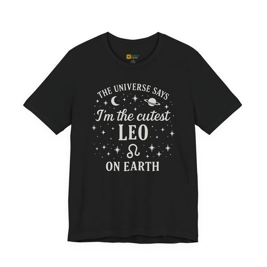 A black T-shirt featuring a white Leo zodiac design that reads “The Universe Says I’m the Cutest Leo on Earth,” with moon, planet and star accents around the lettering.