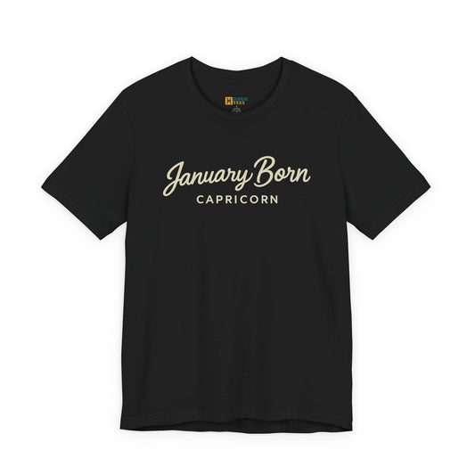 January Born Capricorn T-shirt with minimalist script typography on black fabric.