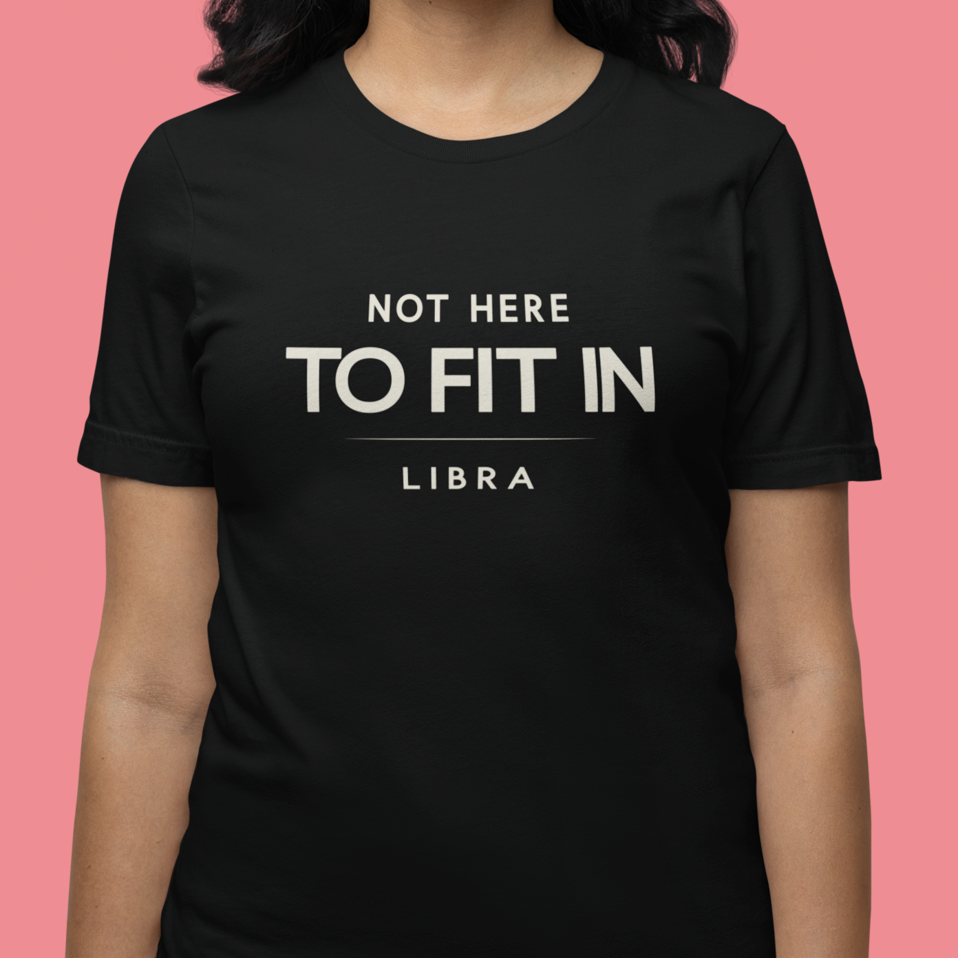 Model wearing Libra zodiac t-shirt with “Not Here to Fit In” typography quote design
