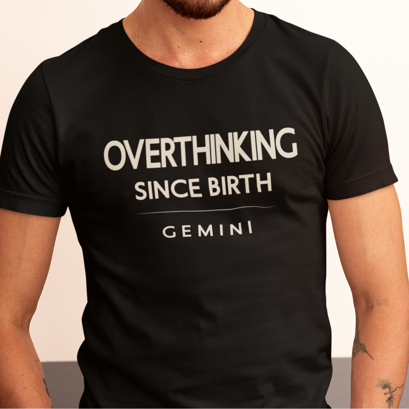 Model wearing Gemini zodiac t-shirt with “Overthinking Since Birth” bold typography design