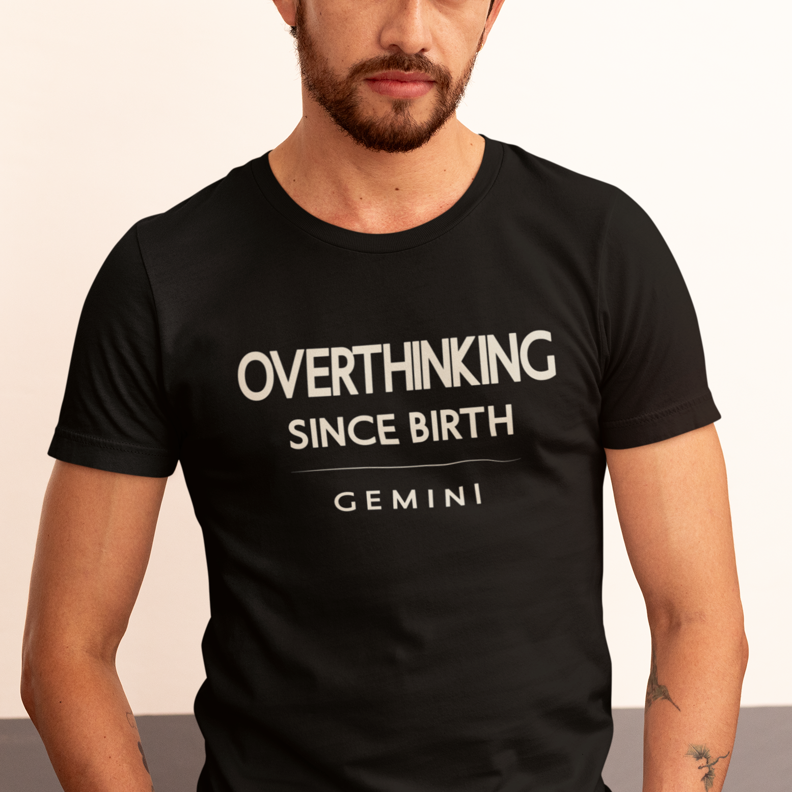 Model wearing Gemini zodiac t-shirt with “Overthinking Since Birth” bold typography design