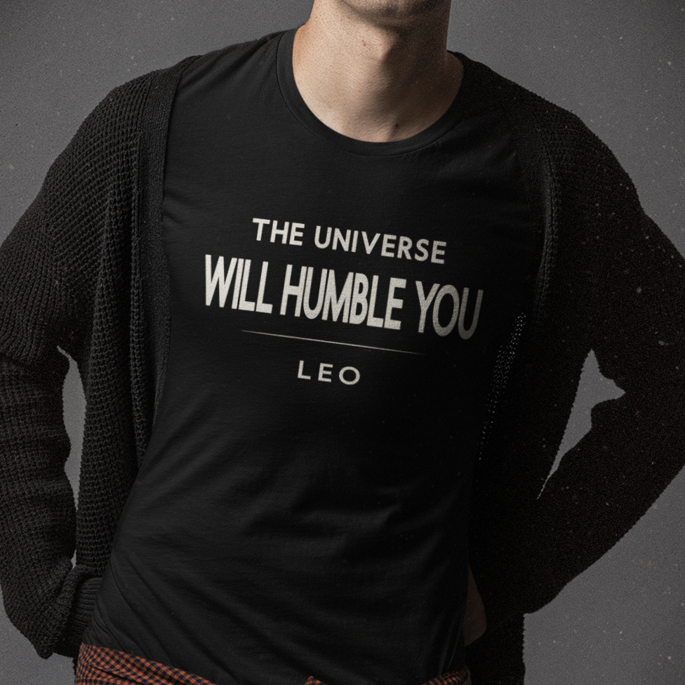 Model wearing Leo zodiac t-shirt with The Universe Will Humble You typography.