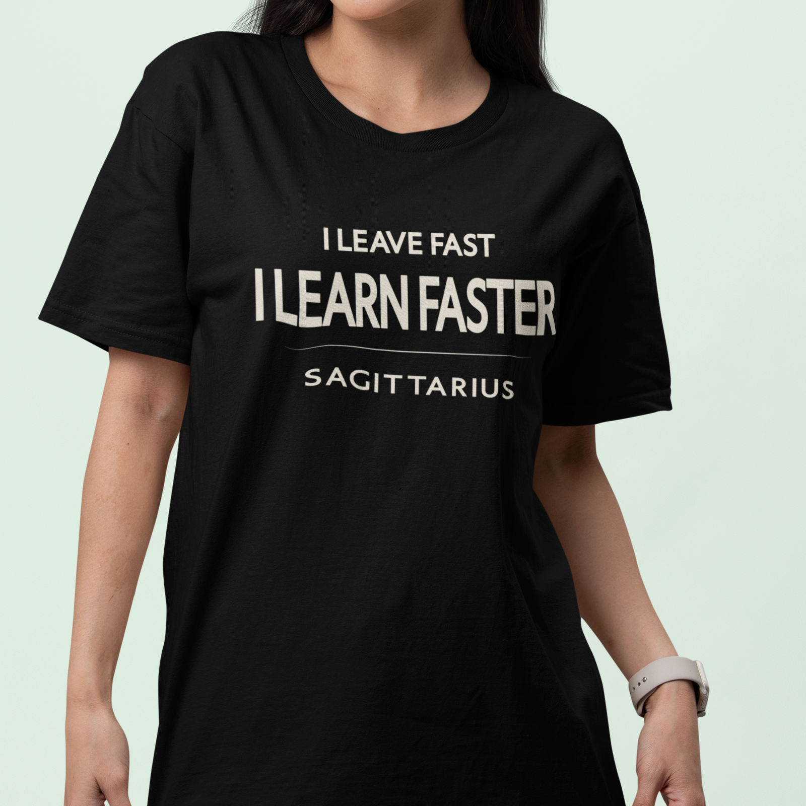 Model wearing Sagittarius zodiac t-shirt with “I Leave Fast I Learn Faster” typography quote