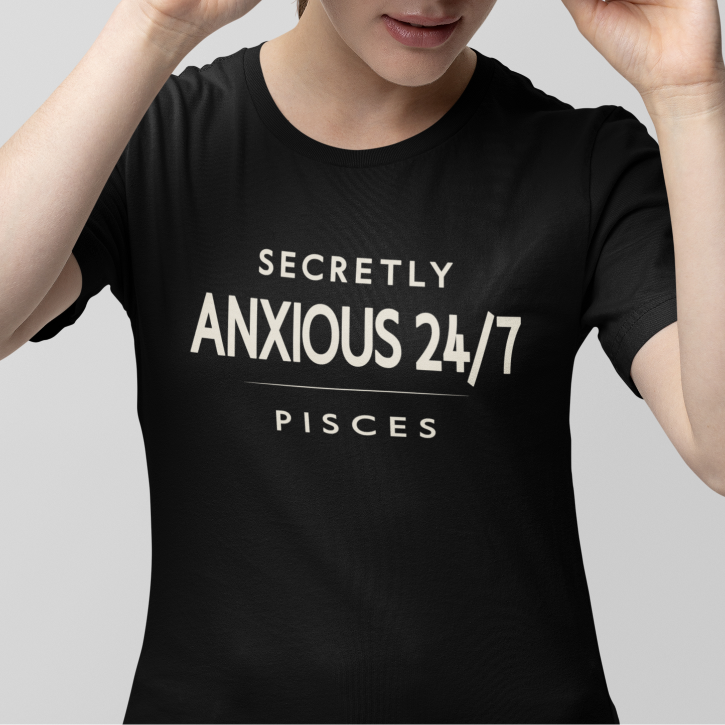 Model wearing Pisces zodiac t-shirt with “Secretly Anxious 24/7” bold typography quote design.