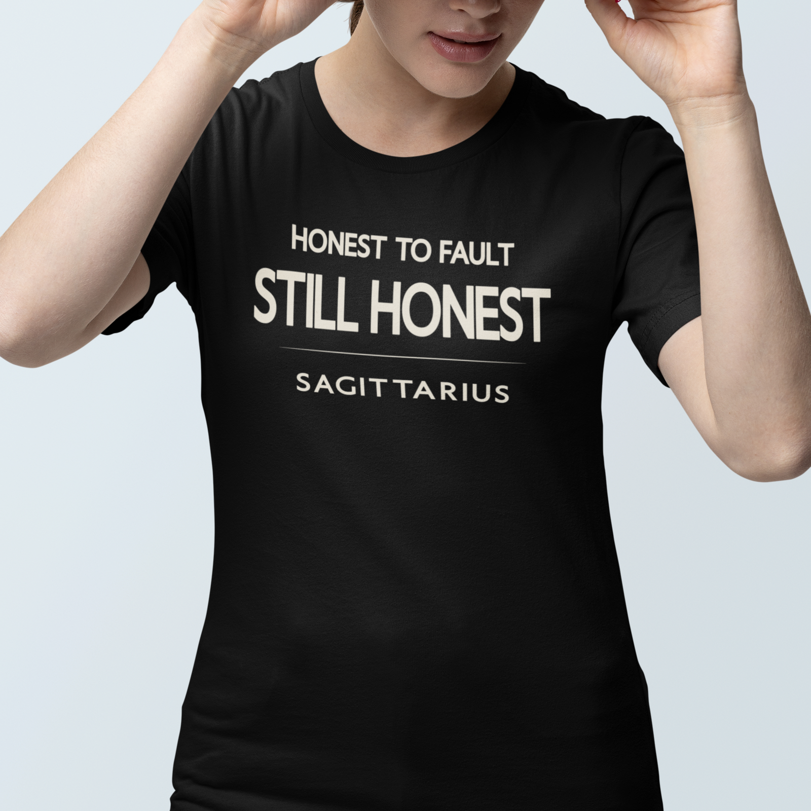 Model wearing Sagittarius zodiac t-shirt with “Honest to Fault Still Honest” typography quote
