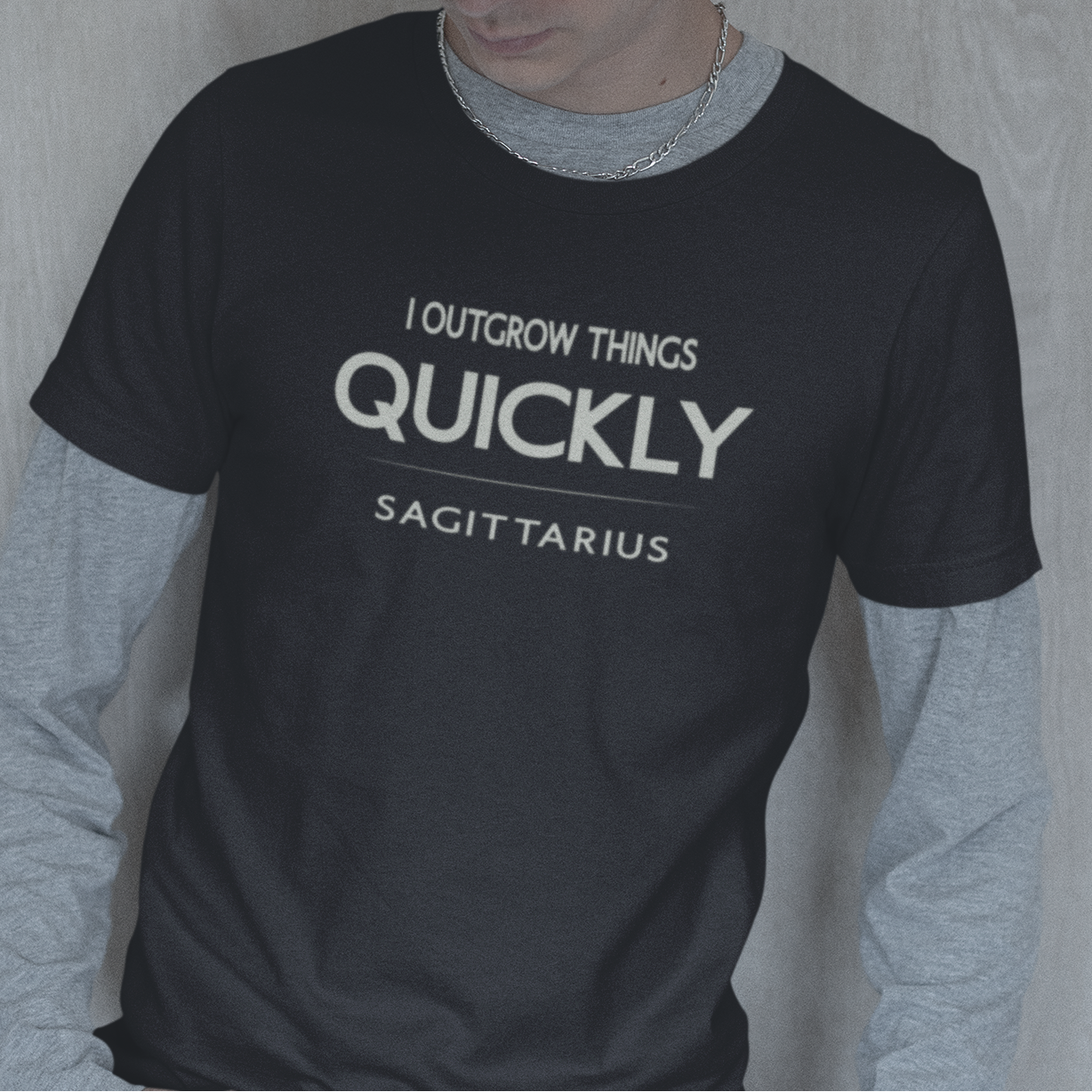 Model wearing Sagittarius zodiac t-shirt with “I Outgrow Things Quickly” typography quote