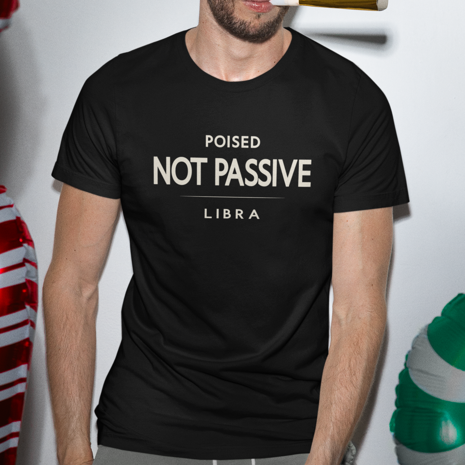 Model wearing Libra zodiac t-shirt with bold “Poised Not Passive” typography quote