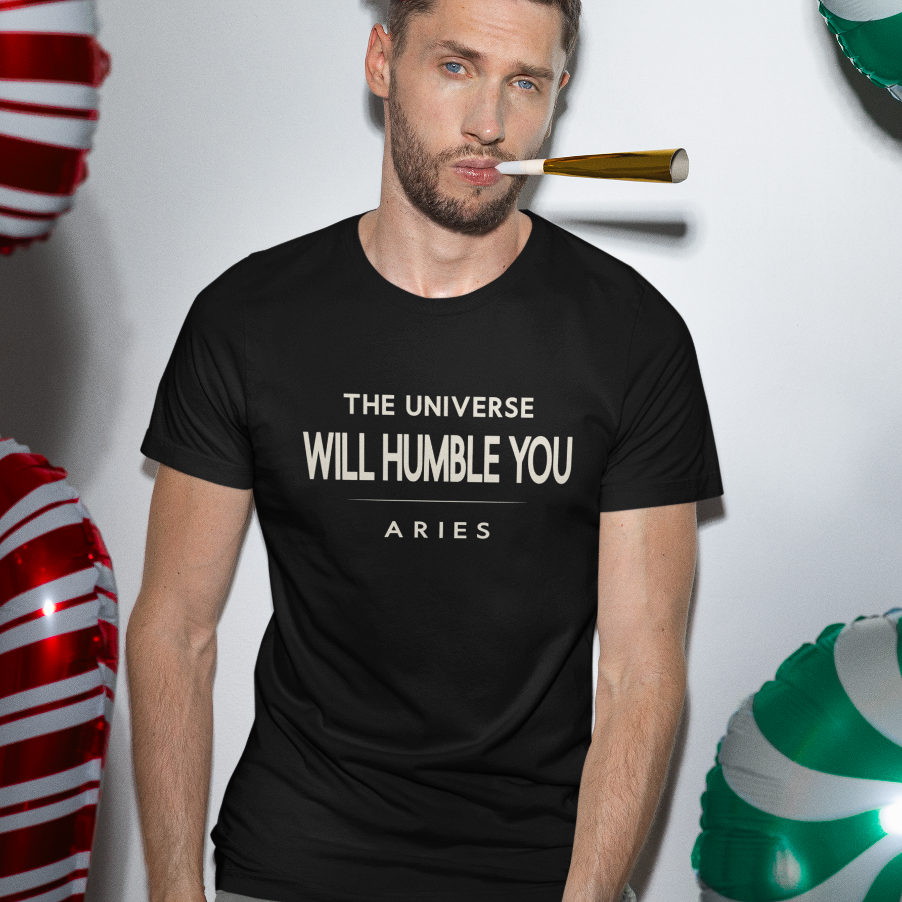 Model wearing Aries zodiac t-shirt with “The Universe Will Humble You” bold typography quote design
