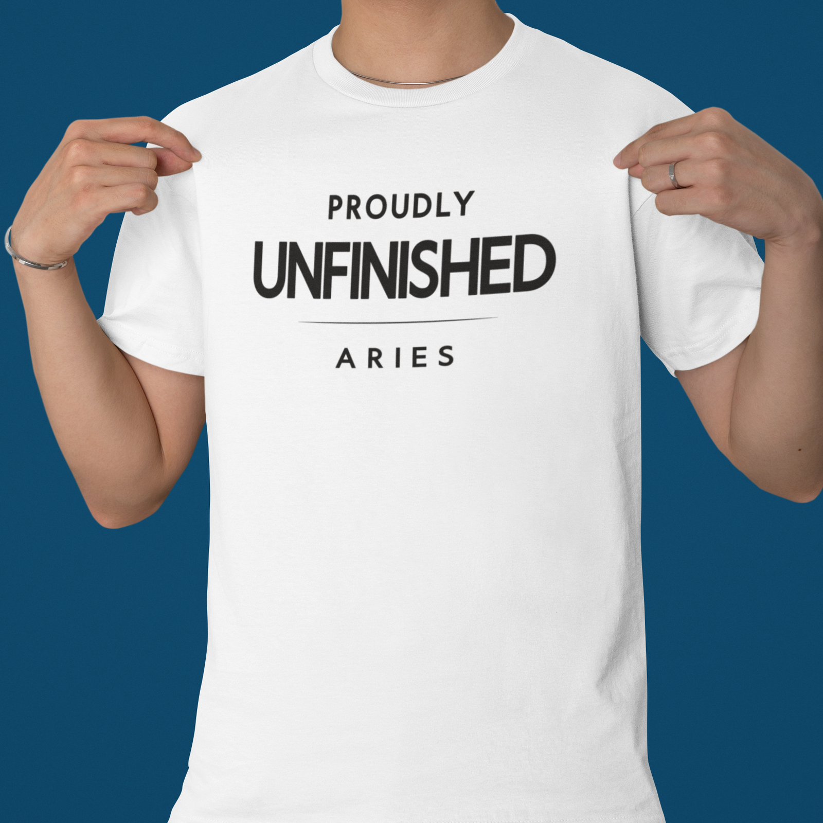 Model wearing Aries zodiac t-shirt with “Proudly Unfinished” typography quote