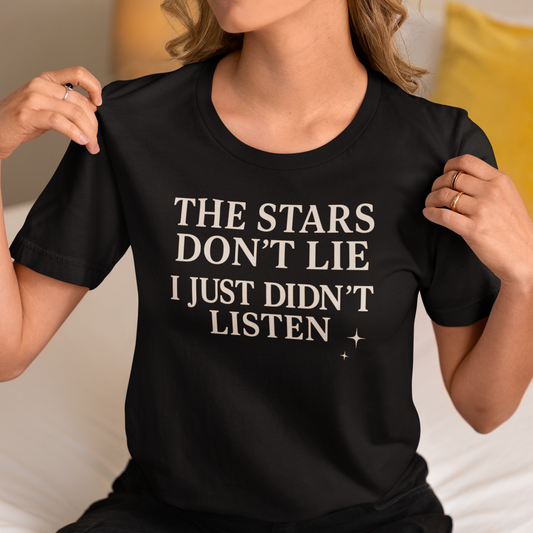 Model wearing zodiac t-shirt with “The Stars Don’t Lie I Just Didn’t Listen” typography statement design.
