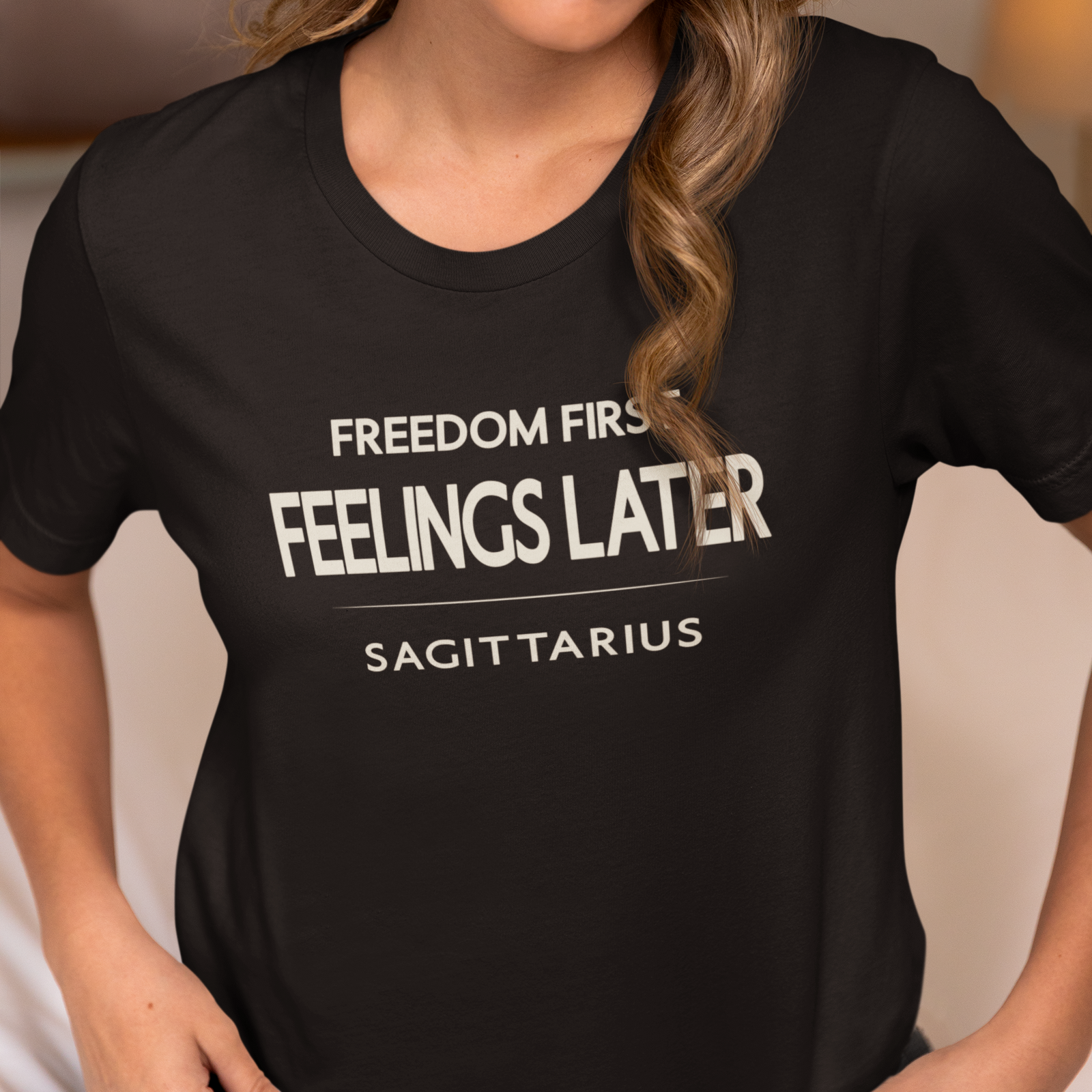 Woman wearing Sagittarius zodiac t-shirt with “Freedom First Feelings Later” typography quote