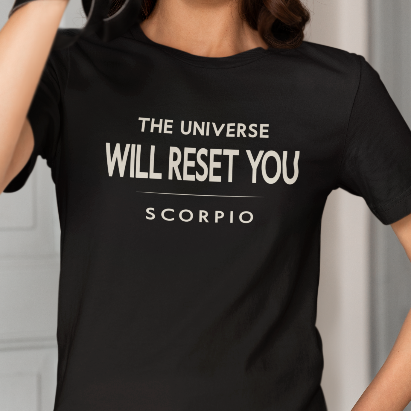 Model wearing Scorpio zodiac t-shirt with The Universe Will Reset You typography.