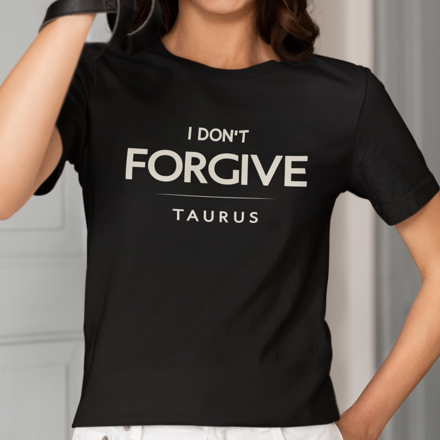 Model wearing Taurus zodiac t-shirt with I Don’t Forgive typography.