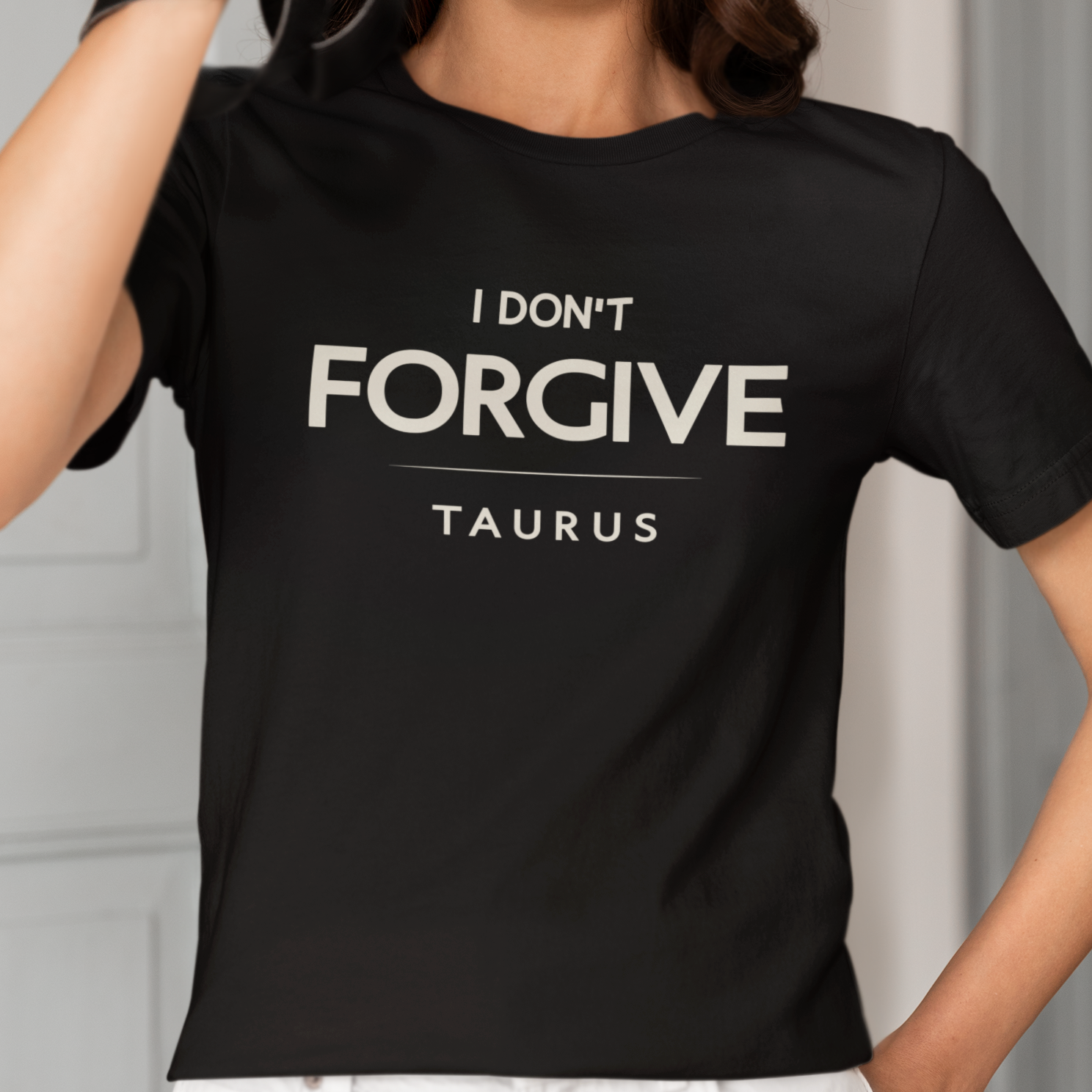 Model wearing Taurus zodiac t-shirt with I Don’t Forgive typography.