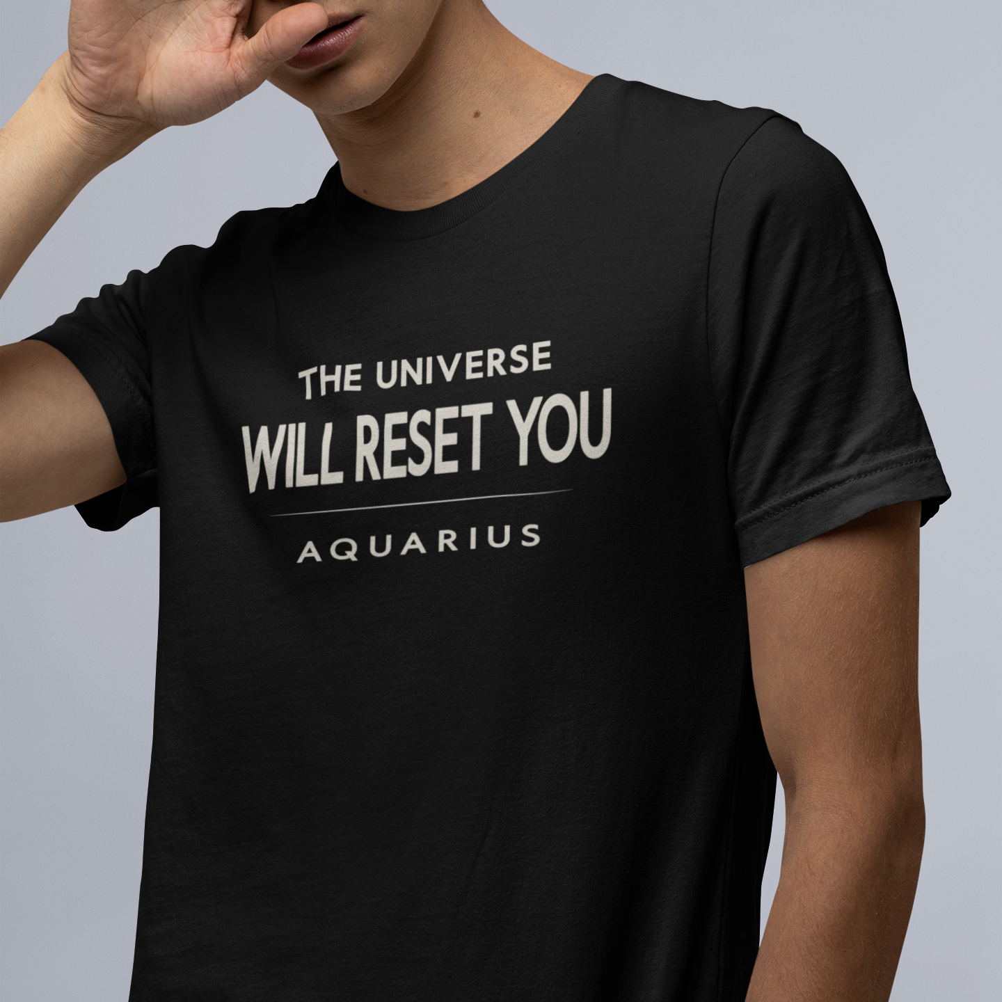 Model wearing Aquarius zodiac t-shirt with “The Universe Will Reset You” typography quote