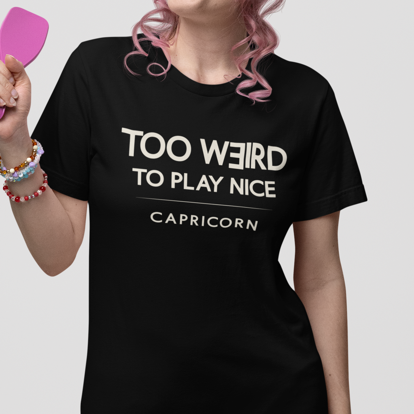 Model wearing Capricorn zodiac t-shirt with “Too Weird to Play Nice” typography quote