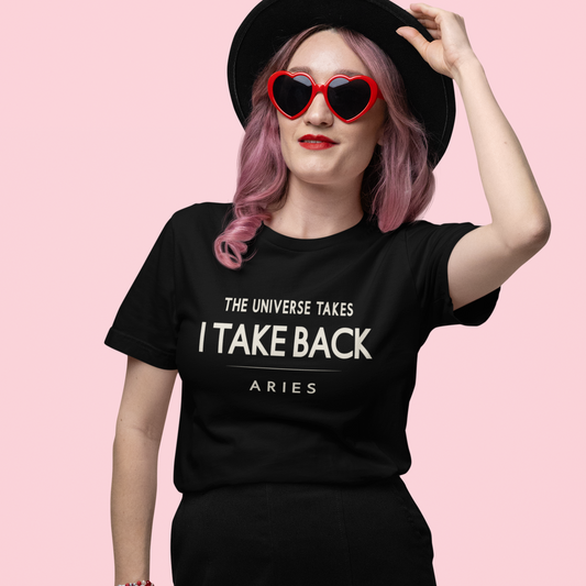 Model wearing Aries zodiac t-shirt with “The Universe Takes, I Take Back” bold typography quote design