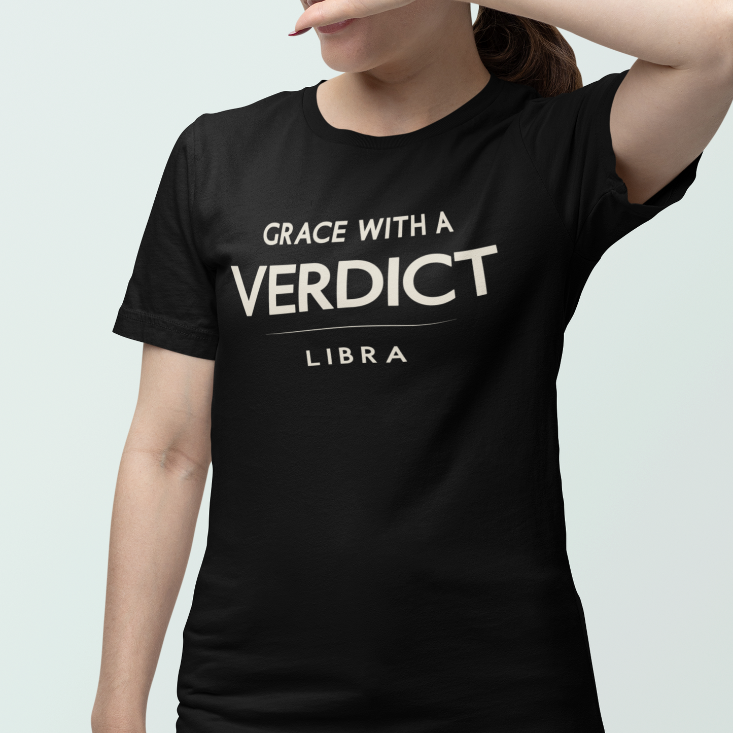 Model wearing Libra zodiac t-shirt with bold “Grace With a Verdict” typography quote