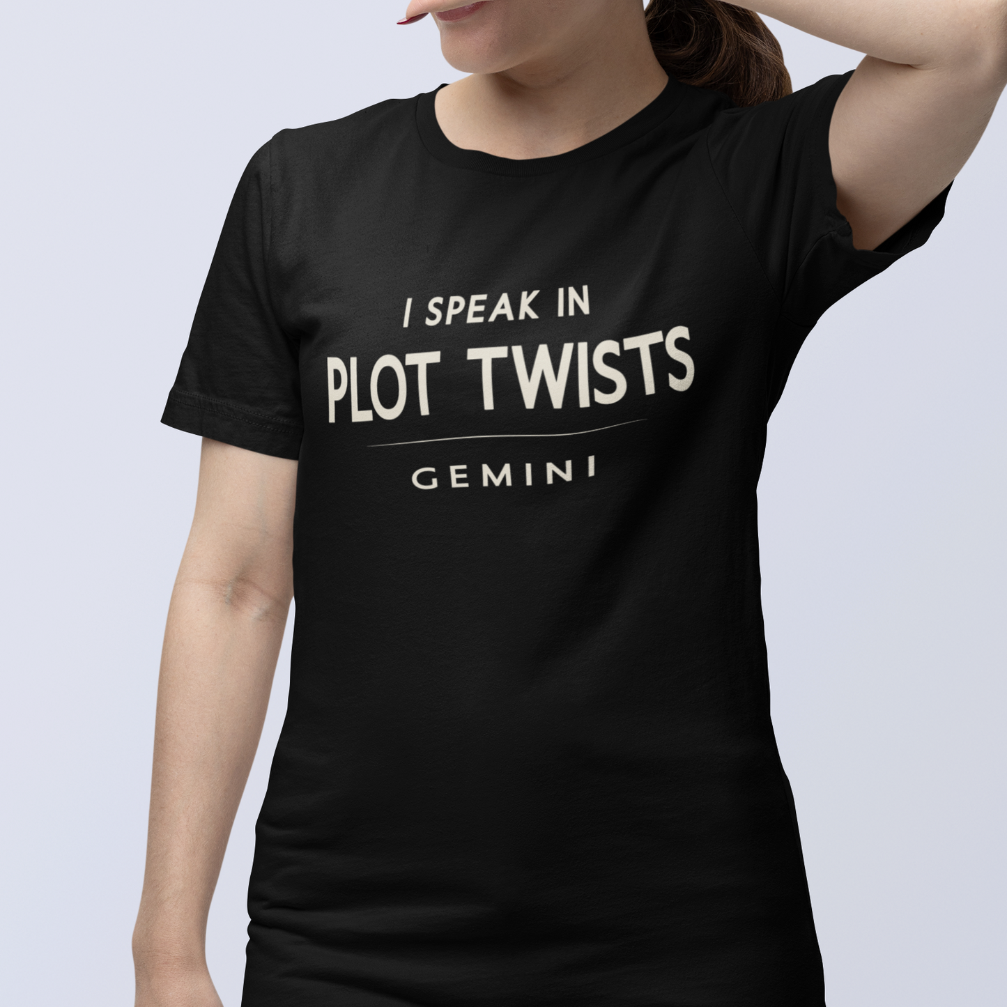 Model wearing Gemini zodiac t-shirt with “I Speak in Plot Twists” typography quote