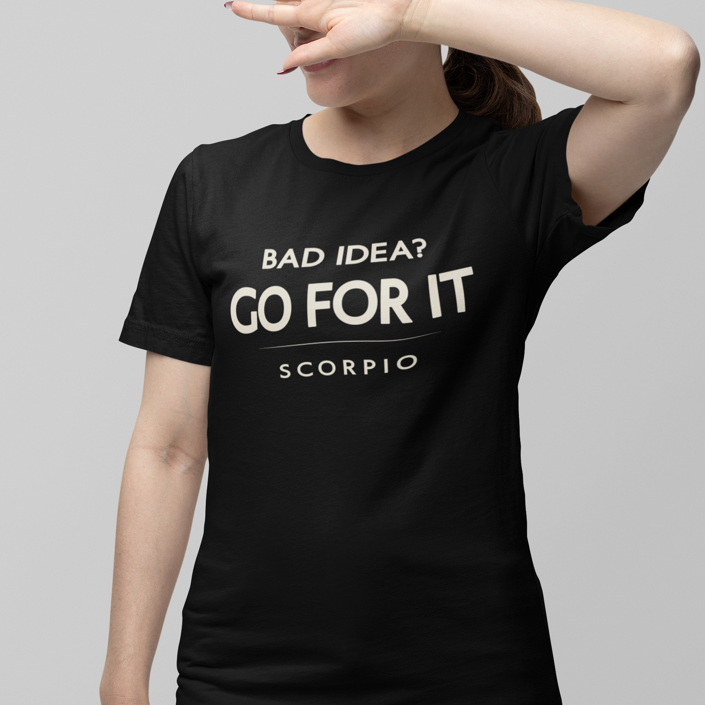 Model wearing Scorpio zodiac t-shirt with “Bad Idea? Go For It” typography quote design