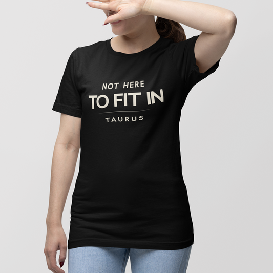 Model wearing Taurus zodiac t-shirt with “Not Here to Fit In” typography quote design