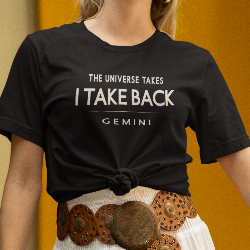 Model wearing Gemini zodiac t-shirt with “The Universe Takes I Take Back” bold typography design