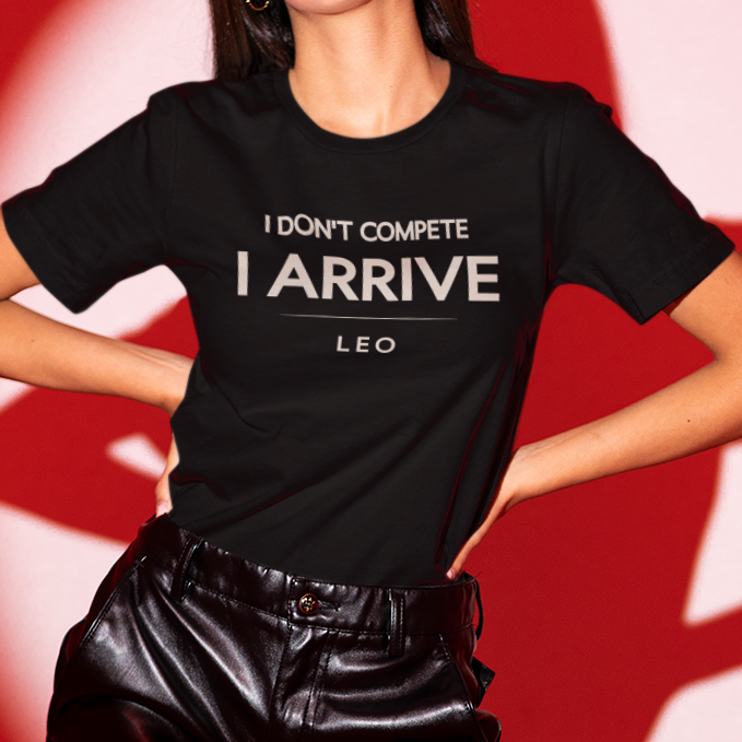 Model wearing Leo zodiac t-shirt with bold “I Don’t Compete I Arrive” typography quote