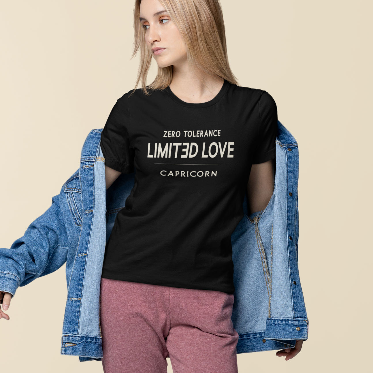 Model wearing Capricorn zodiac t-shirt with “Zero Tolerance Limited Love” typography quote design