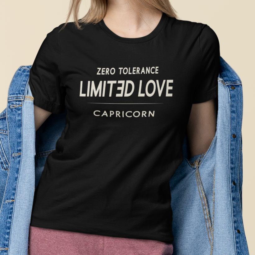Model wearing Capricorn zodiac t-shirt with “Zero Tolerance Limited Love” typography quote design