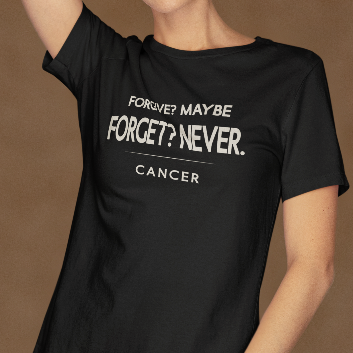 Model wearing black Cancer zodiac t-shirt with “Forgive? Maybe. Forget? Never.” typography