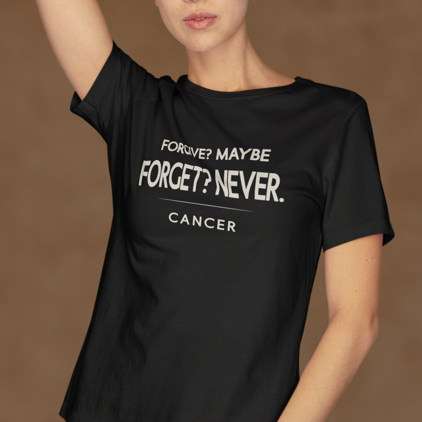 Model wearing black Cancer zodiac t-shirt with “Forgive? Maybe. Forget? Never.” typography