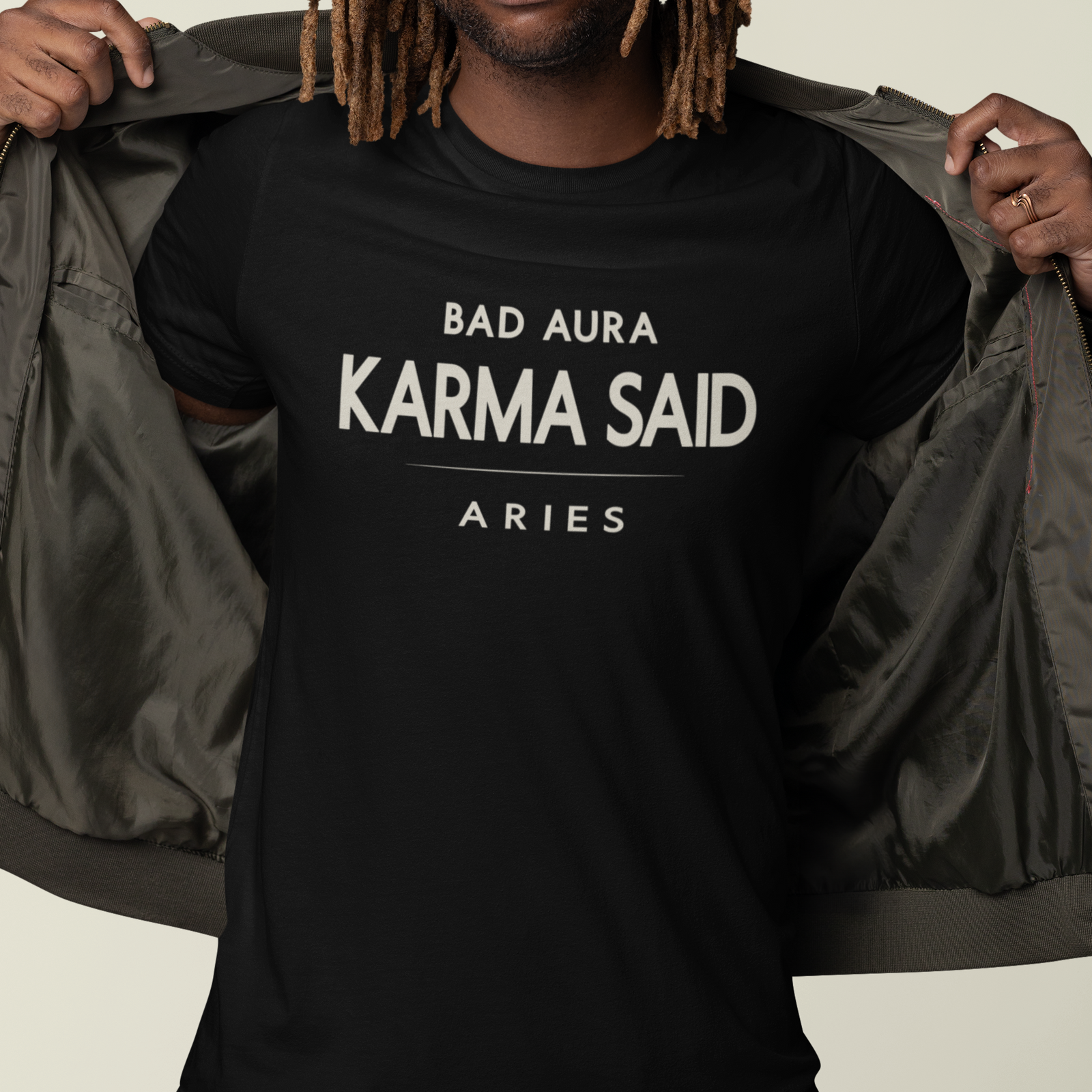 Model wearing Aries zodiac t-shirt with “Bad Aura Karma Said” typography quote