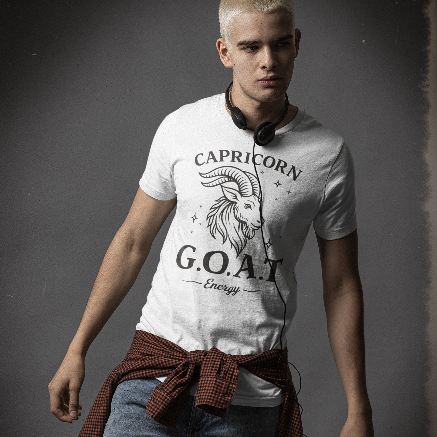 Man wearing a white T-shirt with a black Capricorn G.O.A.T Energy graphic featuring a detailed goat head illustration and stars.