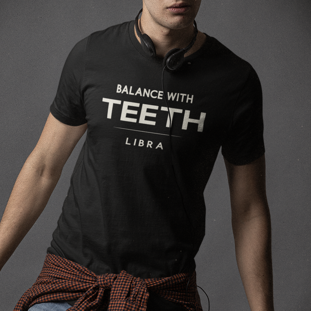 Model wearing Libra zodiac t-shirt with bold “Balance With Teeth” typography quote