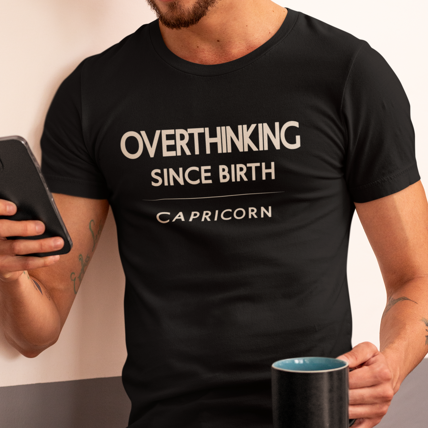 Model wearing Capricorn zodiac t-shirt with “Overthinking Since Birth” typography quote
