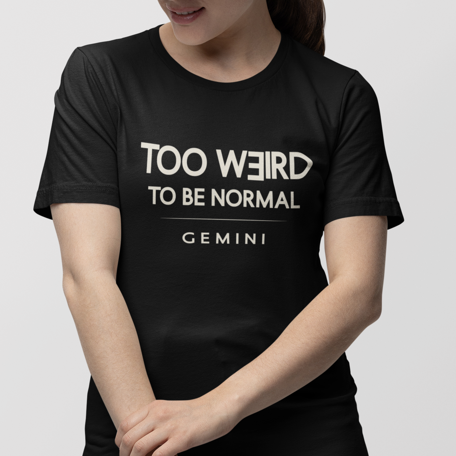 Model wearing Gemini zodiac t-shirt with “Too Weird to Be Normal” typography quote design