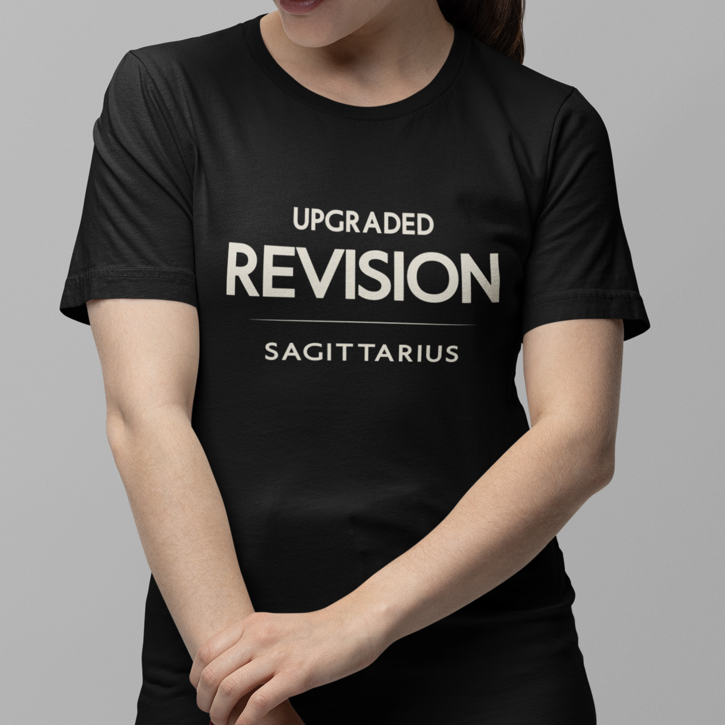 Model wearing Sagittarius zodiac t-shirt with “Upgraded Revision” typography quote design