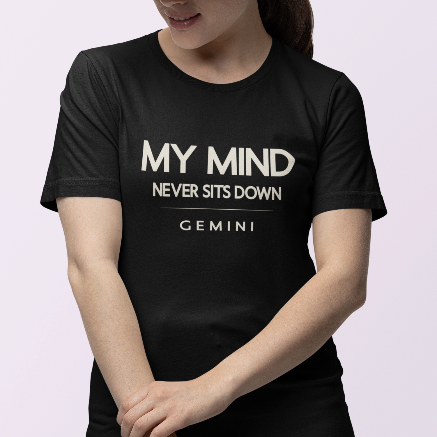 Model wearing Gemini zodiac t-shirt with “My Mind Never Sits Down” typography quote