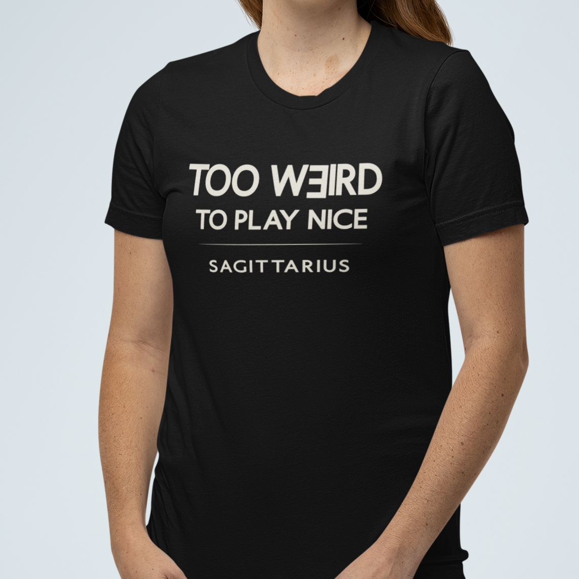 Model wearing Sagittarius zodiac t-shirt with “Too Weird to Play Nice” typography quote