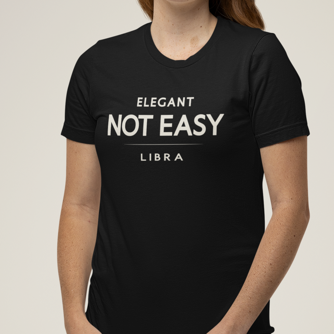 Model wearing Libra zodiac t-shirt with “Elegant Not Easy” typography quote