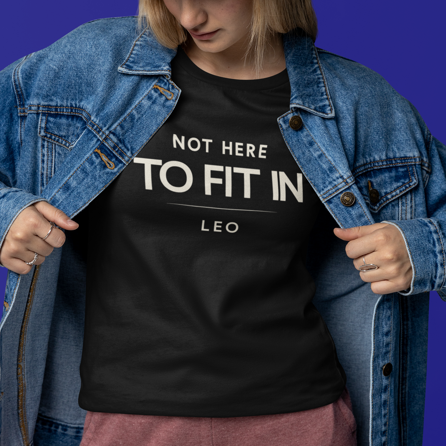 Model wearing Leo zodiac t-shirt with “Not Here to Fit In” typography quote design