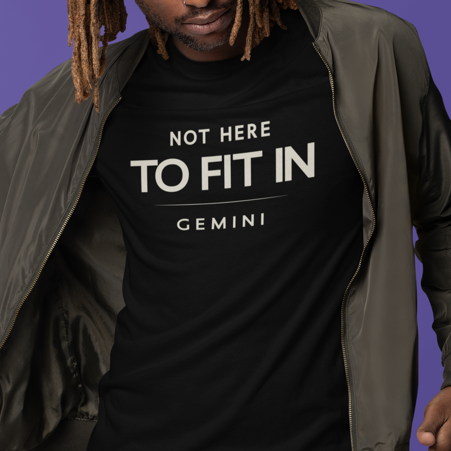 Model wearing Gemini zodiac t-shirt with “Not Here to Fit In” typography quote design