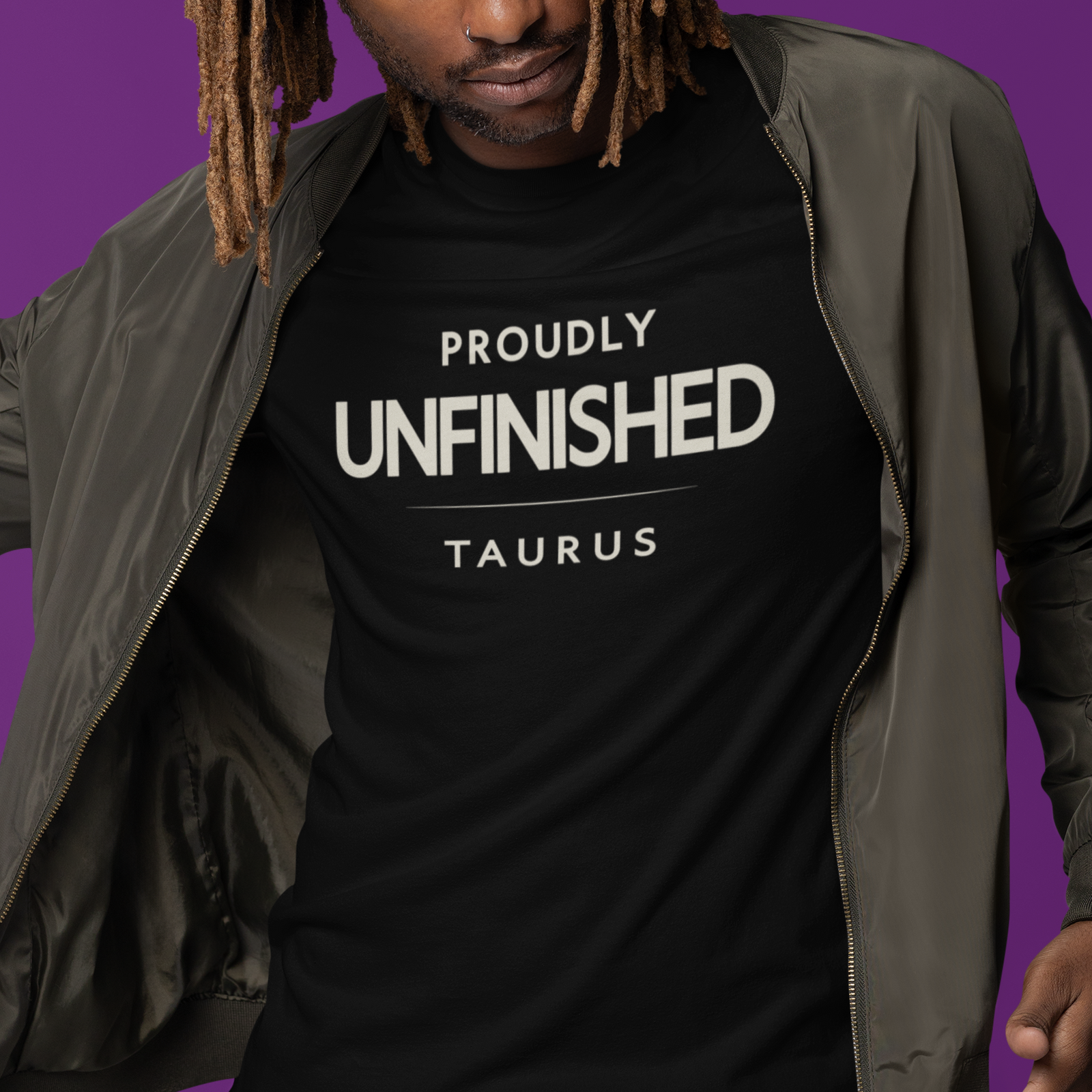 Model wearing Taurus zodiac t-shirt with bold “Proudly Unfinished” typography quote design