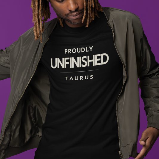 Model wearing Taurus zodiac t-shirt with bold “Proudly Unfinished” typography quote design